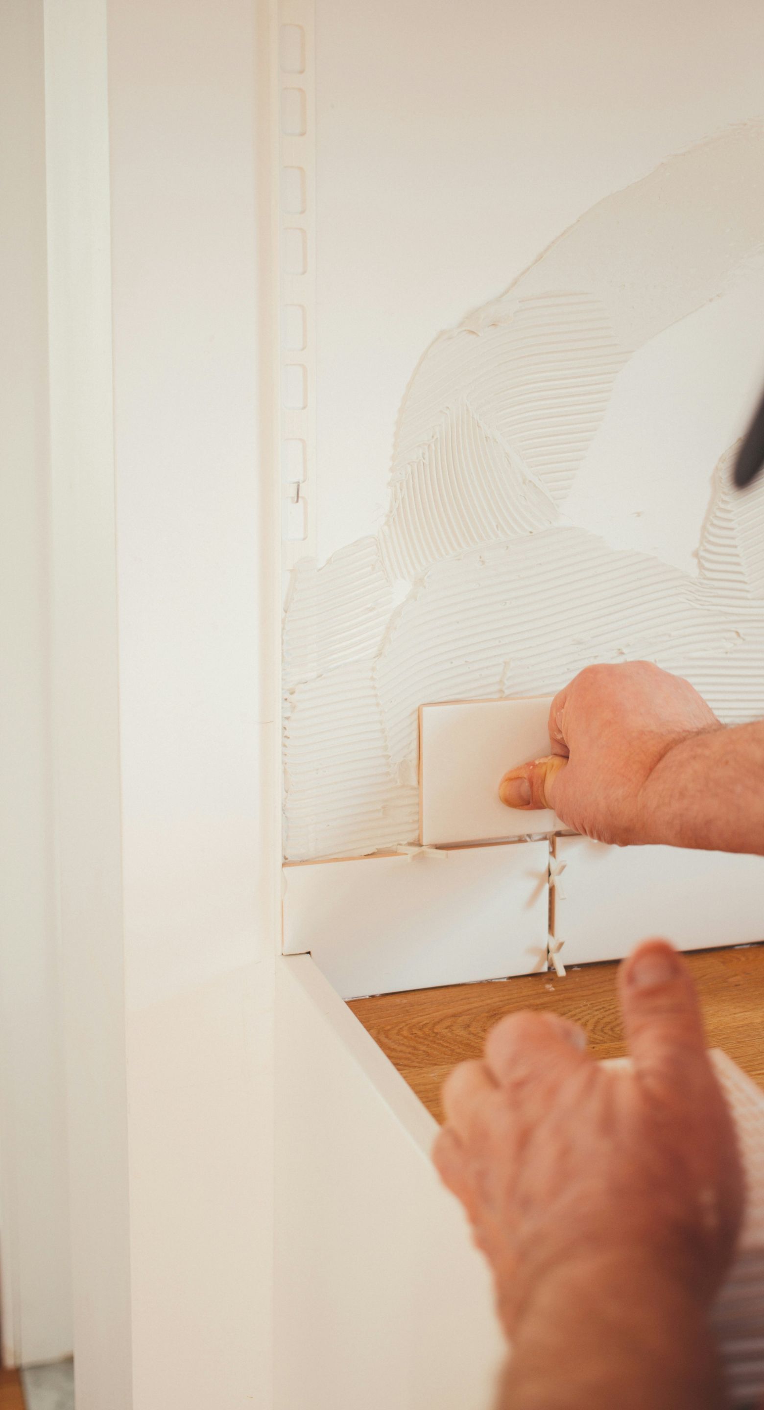 person pressing white wall